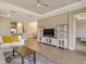 Living room open to the kitchen, featuring white couches, a coffee table, and wood-look tile floors at 5300 Popoli Way, Sarasota, FL 34238