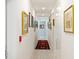 Bright hallway adorned with framed artwork and a runner rug at 540 N Tamiami Trl # 1204, Sarasota, FL 34236