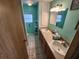 Bathroom with double vanity and teal walls at 5414 Burma Ct, Bradenton, FL 34207
