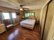Bedroom with wood floors and ceiling fan at 5414 Burma Ct, Bradenton, FL 34207