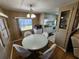 Dining area with a round table and chairs, adjacent to kitchen and living room at 5414 Burma Ct, Bradenton, FL 34207