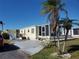 Cute yellow single wide home with carport and screened porch at 5414 Burma Ct, Bradenton, FL 34207