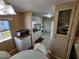 Kitchen features white cabinets, microwave, dishwasher, and adjacent dining area at 5414 Burma Ct, Bradenton, FL 34207