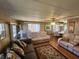 Spacious living room with light beige reclining sofas and wood flooring at 5414 Burma Ct, Bradenton, FL 34207