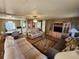 Living room features light brown reclining sofas and wood flooring at 5414 Burma Ct, Bradenton, FL 34207
