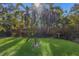 Tropical backyard with lush landscaping, a wooden fence, and plenty of sunshine at 5505 Pheasant Ln, Bradenton, FL 34209