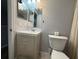 Simple bathroom featuring a sink, toilet, and mirror at 628 Cohen Way # 628, Sarasota, FL 34236