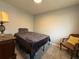 Bedroom featuring a bed with dark gray bedding, light gray walls, carpeted flooring, and classic furniture at 628 Cohen Way # 628, Sarasota, FL 34236