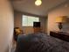 Cozy bedroom with a window, bed, dresser, and chair at 628 Cohen Way # 628, Sarasota, FL 34236