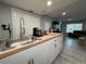 View of the kitchen sink and countertop with the living room visible in the background at 628 Cohen Way # 628, Sarasota, FL 34236