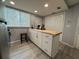 Kitchen with white shaker cabinets, light wood countertops, and stainless steel appliances at 628 Cohen Way # 628, Sarasota, FL 34236