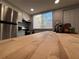 Close-up of a kitchen island with butcher block countertop, sink, and appliances at 628 Cohen Way # 628, Sarasota, FL 34236
