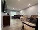 Living room featuring a brown leather sectional sofa, wood-look floors, and neutral decor at 628 Cohen Way # 628, Sarasota, FL 34236