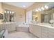 Bright bathroom with dual sinks, a soaking tub, and a separate shower at 7223 Orchid Island Pl, Bradenton, FL 34202