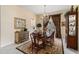 Elegant dining room featuring a chandelier, rich wood table, and decorative rug at 7223 Orchid Island Pl, Bradenton, FL 34202