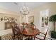 Spacious dining room with a dark wood table, seating for six, and a view into the kitchen at 7223 Orchid Island Pl, Bradenton, FL 34202