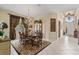 The dining room boasts an ornate chandelier, seating for six, and decorative window treatments at 7223 Orchid Island Pl, Bradenton, FL 34202