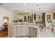 Open concept kitchen with white cabinets, stainless steel appliances, and view to the living room at 7223 Orchid Island Pl, Bradenton, FL 34202