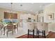 Open floor plan kitchen and dining area with white cabinets, stainless appliances, and chandelier at 7223 Orchid Island Pl, Bradenton, FL 34202