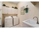 Convenient laundry room with washer, dryer, and utility sink at 7223 Orchid Island Pl, Bradenton, FL 34202