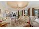 Spacious living room with built-in shelving, hardwood floors, and coffered ceiling at 7223 Orchid Island Pl, Bradenton, FL 34202