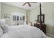 This bedroom offers a four poster bed, shutters, neutral-toned walls, and a ceiling fan at 7223 Orchid Island Pl, Bradenton, FL 34202