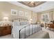 Airy main bedroom with a decorative ceiling, bench seat and multiple windows at 7223 Orchid Island Pl, Bradenton, FL 34202