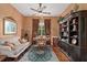 Comfortable home office featuring hardwood floors, ceiling fan, stylish sofa and desk at 7223 Orchid Island Pl, Bradenton, FL 34202