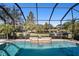 Inviting screened pool with a water feature and lake view at 7223 Orchid Island Pl, Bradenton, FL 34202