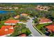 Aerial view of single Gathering homes, green trees and red tile roofs at 750 Foggy Morn Ln, Bradenton, FL 34212