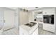 Kitchen features an island with cooktop and ample storage at 805 Harrington Lake N Dr # 76, Venice, FL 34293