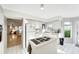 Open kitchen with island cooktop, view of living room and pool at 805 Harrington Lake N Dr # 76, Venice, FL 34293
