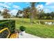 Peaceful backyard with pond view, lush greenery, and a wooden bench at 8608 Stargazer St, Sarasota, FL 34238