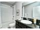 Clean bathroom with tub, shower, and dark vanity at 8608 Stargazer St, Sarasota, FL 34238