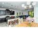 Open concept dining area and kitchen with granite island and modern fixtures at 8608 Stargazer St, Sarasota, FL 34238