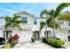 Front view of charming townhome with white garage doors and landscaping at 8608 Stargazer St, Sarasota, FL 34238