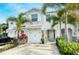 Two-story townhome with white garage door and landscaping at 8608 Stargazer St, Sarasota, FL 34238