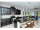 Modern kitchen with dark cabinetry, granite counters, and stainless steel appliances at 8608 Stargazer St, Sarasota, FL 34238