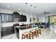 Modern kitchen with dark cabinetry, granite countertops, and stainless steel appliances at 8608 Stargazer St, Sarasota, FL 34238