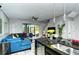 Open concept kitchen and living room with island and sectional sofa at 8608 Stargazer St, Sarasota, FL 34238