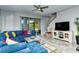 Comfortable living room featuring a sectional sofa, a large TV and access to screened patio at 8608 Stargazer St, Sarasota, FL 34238