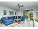 Spacious living room with sectional sofa, large windows, and access to screened patio at 8608 Stargazer St, Sarasota, FL 34238