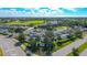 Aerial view of community clubhouse with parking and golf course at 8753 Pebble Creek Ln, Sarasota, FL 34238