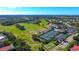 Aerial view of community with golf course, pool, tennis courts at 8753 Pebble Creek Ln, Sarasota, FL 34238