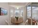 Bright breakfast nook with wooden table and view to the backyard at 8753 Pebble Creek Ln, Sarasota, FL 34238