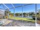 Spacious screened patio boasts lake views and comfortable seating at 8753 Pebble Creek Ln, Sarasota, FL 34238