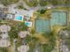 Aerial view of community amenities including a pool, tennis courts, and parking at 11866 Northtrail Ave # 11866, Temple Terrace, FL 33617