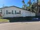 Tan house with attached garage and green shutters at 1202 42Nd W St, Bradenton, FL 34205