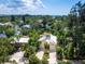 Bright yellow canal front property with tropical landscaping on waterfront with bay views at 1214 Sea Plume Way, Sarasota, FL 34242