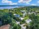 Aerial shot showcasing a bright yellow home with lush tropical landscaping and canal-front access at 1214 Sea Plume Way, Sarasota, FL 34242